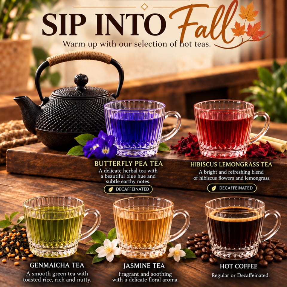 Autumn tea display featuring a black teapot and colorful cups of butterfly pea, hibiscus lemongrass, genmaicha, jasmine tea, and coffee.